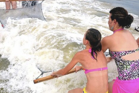 a girl riding a wave on a surfboard in the water